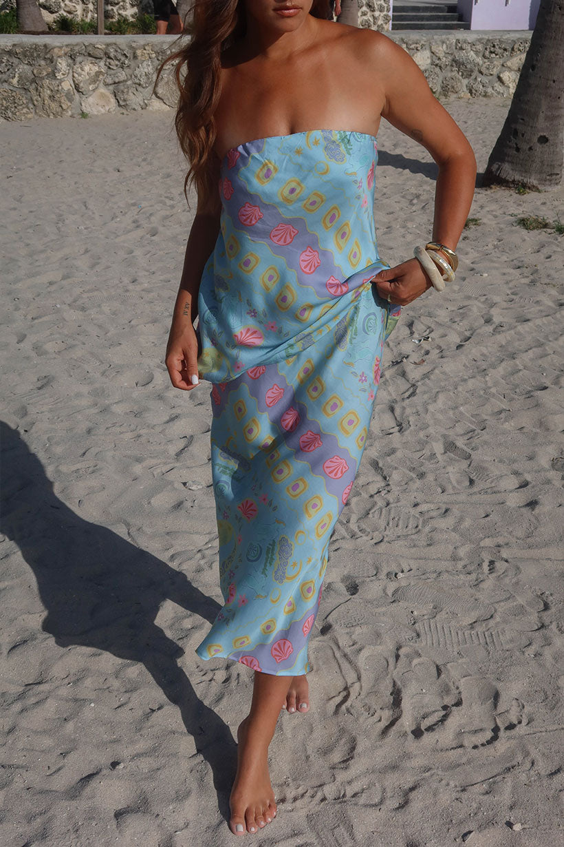 Woman wearing a colourful strapless dress on a beach. Spell, Silk top and skirt, boho, byron bay.
